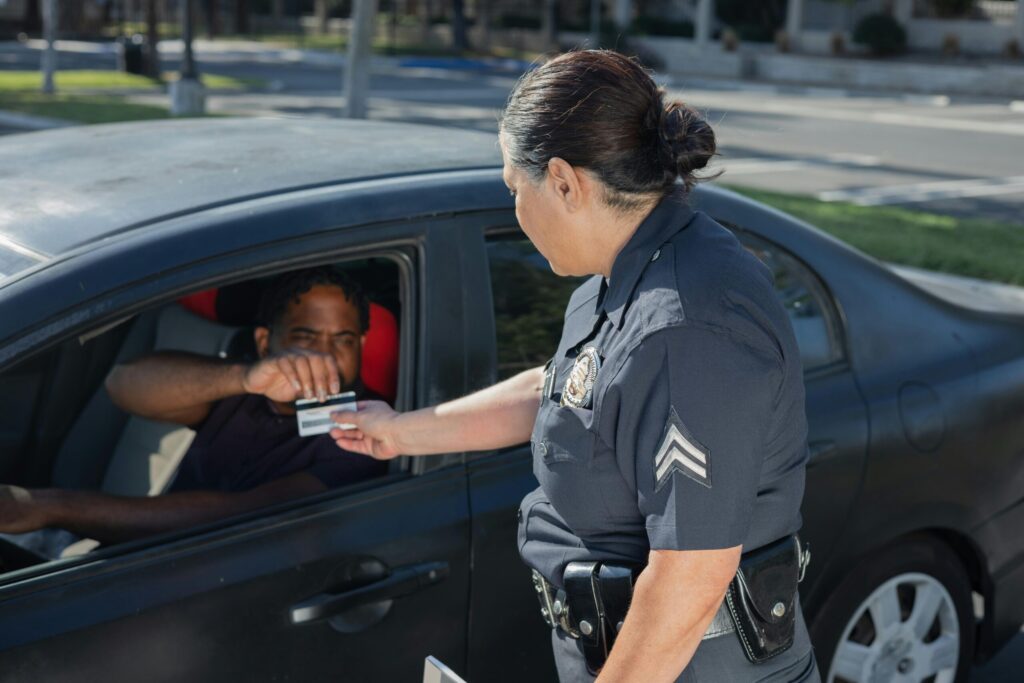 driver handing cop license